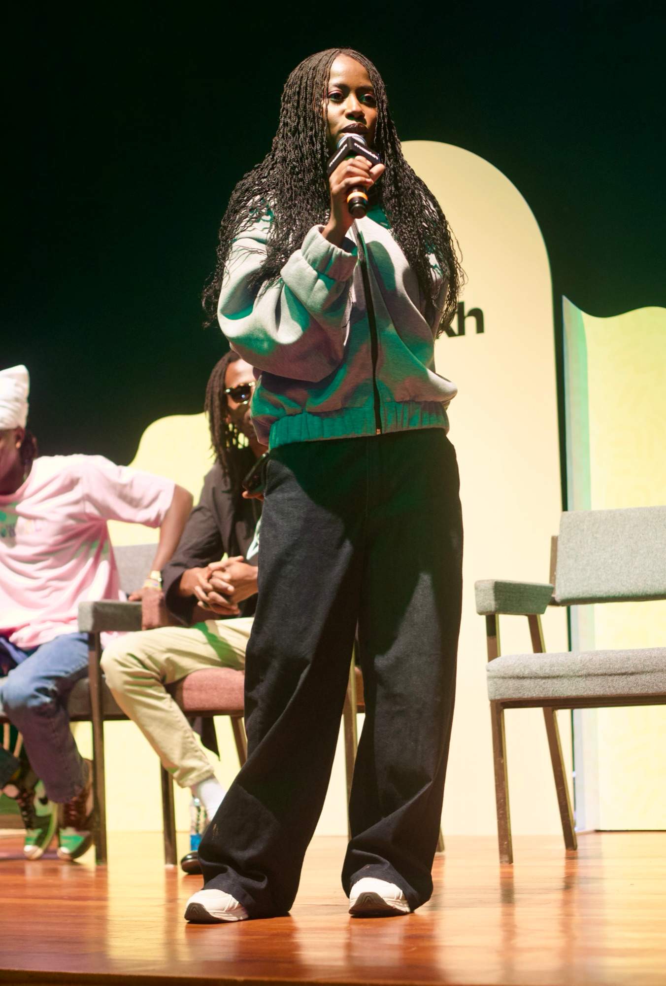 A MOOKH team member speaking on stage